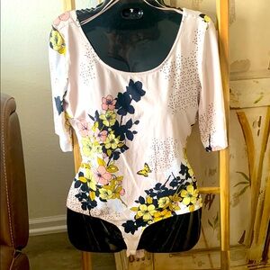 GUESS island like floral scene on front and back bodysuit background pale pink